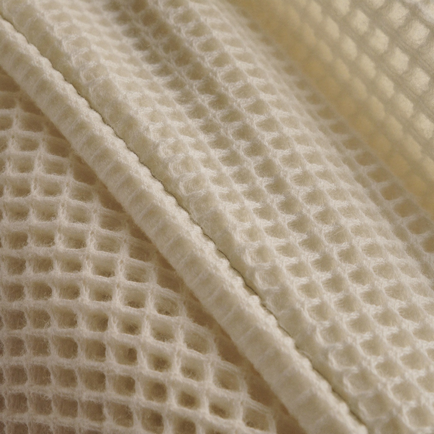 Close-up of the crinkled open weave of layered cotton muslin